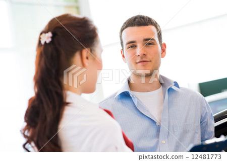Consultant in the showroom and the buyer 12481773