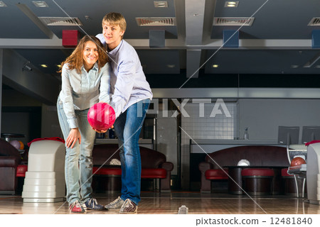 young couple plays bowling 12481840