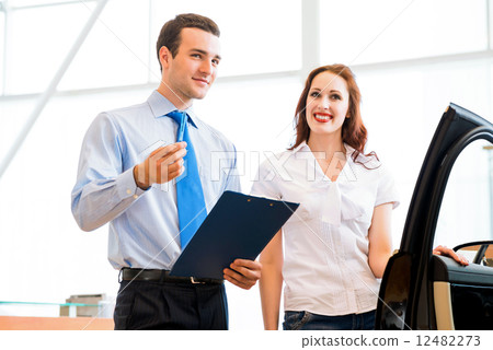 Consultant in the showroom and the buyer 12482273