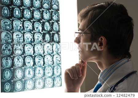 male doctor looking at the x-ray image male doctor looking at the x-ray image 12482479
