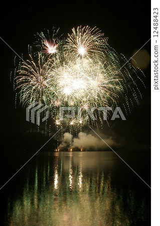 Colorful fireworks on the black sky background and water reflect Colorful fireworks on the black sky background and water reflect 12488423
