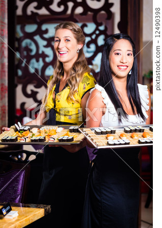 Waitress with sushi in asian restaurant Waitress with sushi in asian restaurant 12490398