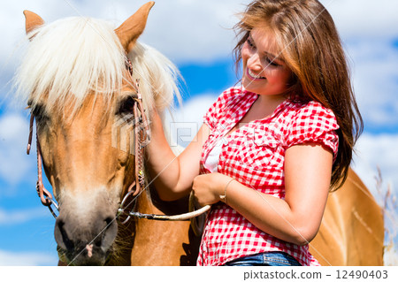 Woman petting horse on pony farm Woman petting horse on pony farm 12490403
