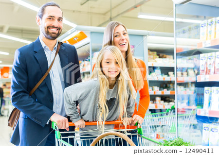 Family with shopping cart in supermarket store Family with shopping cart in supermarket store 12490411