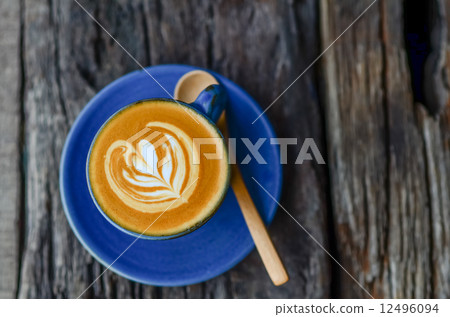 Latte art, Blue coffee cup on wooden background 12496094