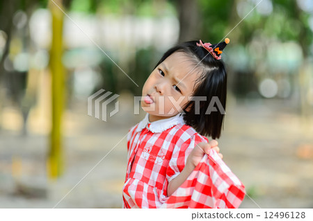 Cute Asian girl show her tongue and funny face. Cute Asian girl show her tongue and funny face. 12496128