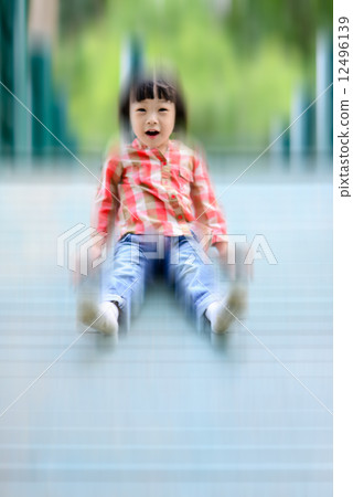 Happy Asian girl playing at playground, motion blur. Happy Asian girl playing at playground, motion blur. 12496139