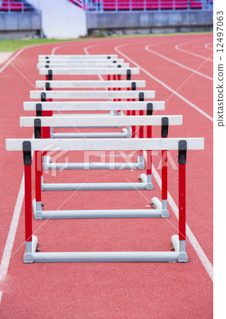 hurdles on the red running track hurdles on the red running track 12497063