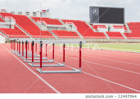 hurdles on the red running track hurdles on the red running track 12497064