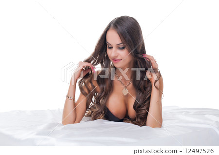 Beautiful busty woman posing shyly at camera Beautiful busty woman posing shyly at camera 12497526