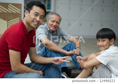 three generation asian men enjoying family bonding time together 12499221