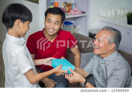 3 generation Asian family enjoying a bonding moment together at home 12499269