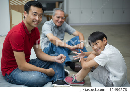 Three generation of family male enjoying a bonding moment  12499278