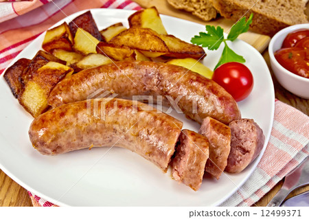Sausages pork fried with potatoes in plate on board Sausages pork fried with potatoes in plate on board 12499371