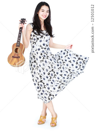 Attractive asian girl playing ukulele Attractive asian girl playing ukulele 12501012