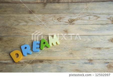 Colorful wooden word Dream on wooden floor Colorful wooden word Dream on wooden floor 12502097
