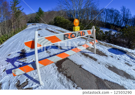 road block set up before snowy and icy road 12503290