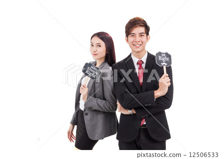 Smiling office couple posing holding placards 12506533