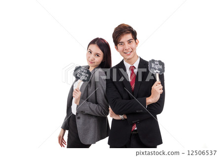 Smiling office couple posing holding placard 12506537