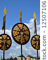 Oriental shields with gilded decoration hanging on decorative spears 12507106