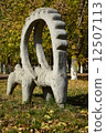 Stone statue featuring a wether with big horns- in the park of Astana, Kazakhstan 12507113