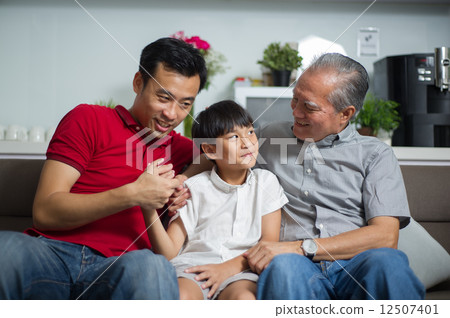 Young Asian child / boy interacting with his father and grand father 12507401