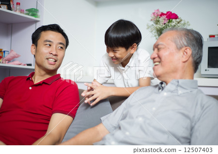 Young Asian child / boy interacting with his father and grand father 12507403