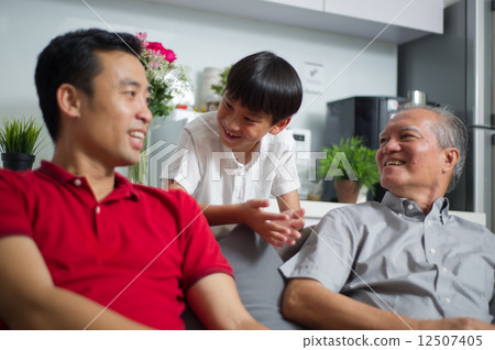 Young Asian child / boy interacting with his father and grand father 12507405