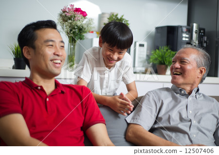 Young Asian child / boy interacting with his father and grand father 12507406