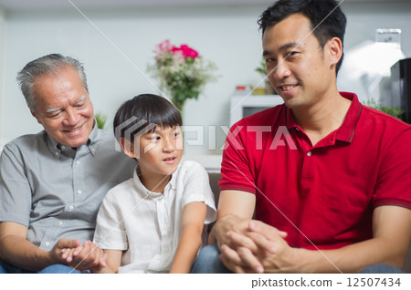 Young asian boy is spending time having conversation with his father and grandfather 12507434