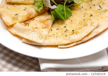 garlic pita bread pizza with salad on top 12508329