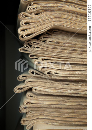 A stack of old newspapers. 12510592