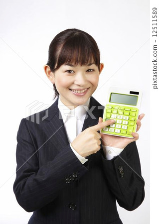 A woman using a calculator A woman using a calculator 12511589