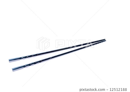 Black chopsticks on white surface Black chopsticks on white surface 12512188