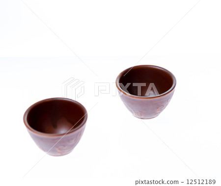 Two small sake or soju glasses on white background Two small sake or soju glasses on white background 12512189
