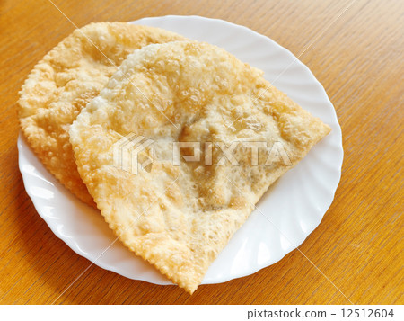 cheburek pie on white plate cheburek pie on white plate 12512604