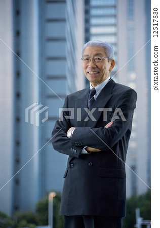 High-rise building in the evening Executive who stands with arms around the city 12517880