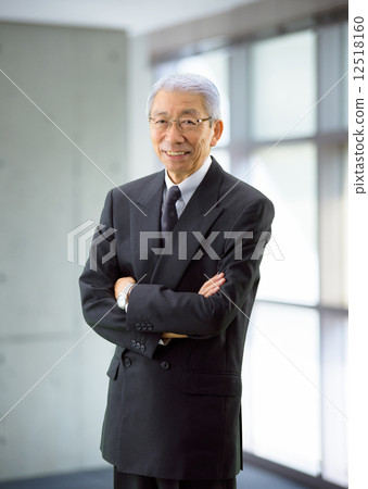 A businessman standing by the window A businessman standing by the window 12518160