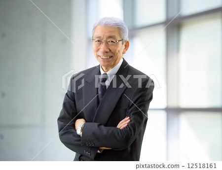 A businessman standing by the window A businessman standing by the window 12518161