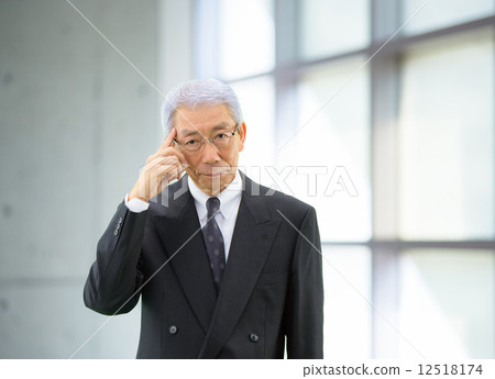 A businessman standing by the window 12518174
