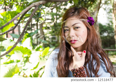 Filipina woman in a garden Filipina woman in a garden 12518477