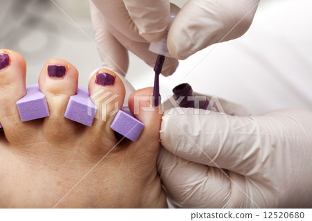 Toenails are painted in fuchsia color 12520680