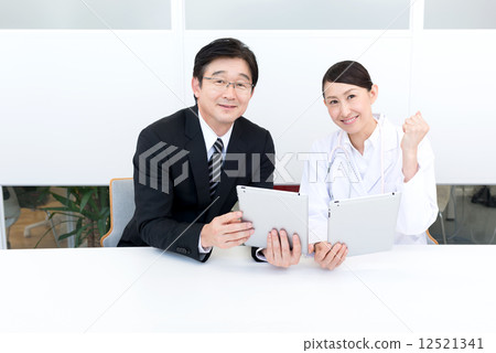 Businessman and doctor tablet guts pose Businessman and doctor tablet guts pose 12521341