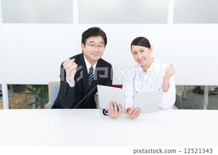 Businessman and doctor tablet guts pose 12521343