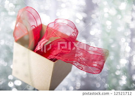 open christmas gift box with red ribbon  in it 12521712