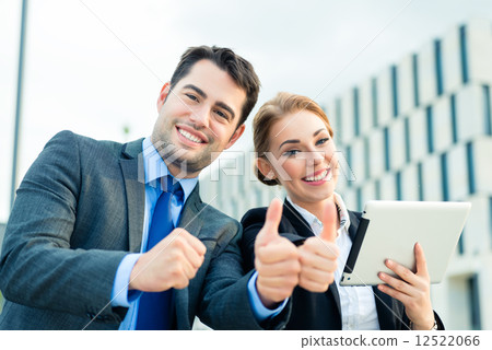 Businesspeople working outdoor with success Businesspeople working outdoor with success 12522066