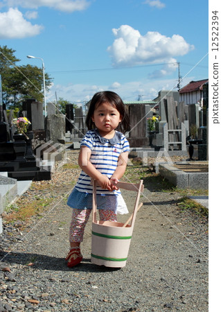 A girl who is visiting a grave 12522394