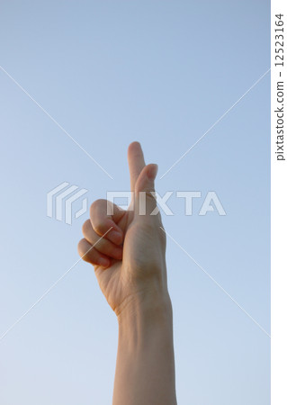 A finger pointing upward 12523164