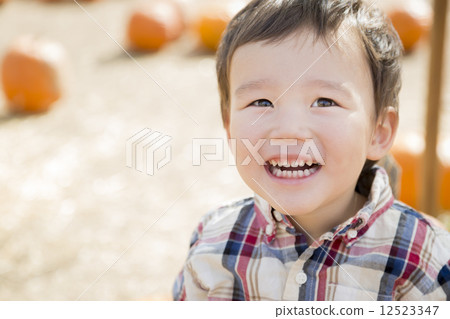Mixed Race Young Boy Having Fun at the Pumpkin Patch 12523347