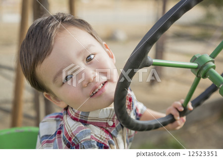 Mixed Race Young Boy Playing on Tractor Mixed Race Young Boy Playing on Tractor 12523351